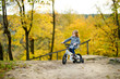 Adorable girl riding a bike on an autumn day