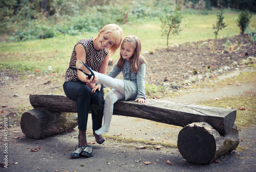 Photo: happy young mother with the daughter in park happy young mother with the daughter in park