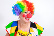 Clown looking to the copy space area in a white studio