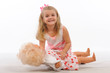 Sweety girl playing with doll isolated white background