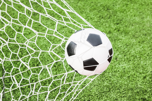 Photo: football in the goal net football in the goal net
