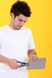 young tiler at work against yellow studio background
