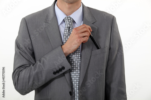 Photo: Businessman putting a pen in his pocket Businessman putting a pen in his pocket