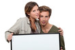 happy couple holding a blank poster