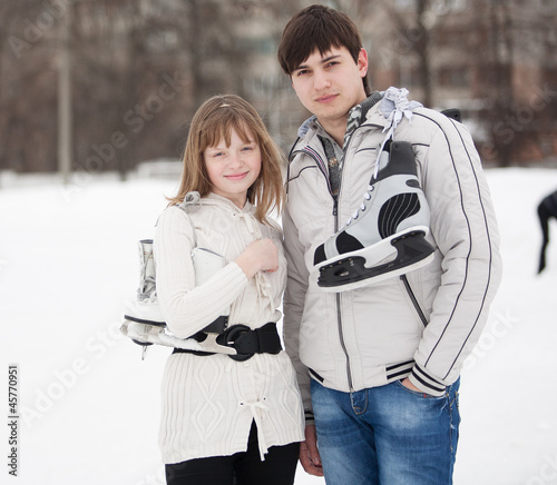 Photo: Portrait of young couple on ice skate rink Portrait of young couple on ice skate rink