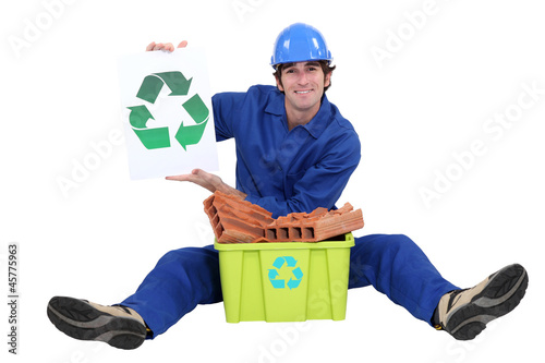 Photo: Builder sat with box of rubble to be recycled Builder sat with box of rubble to be recycled