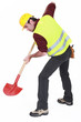 A male construction worker digging.