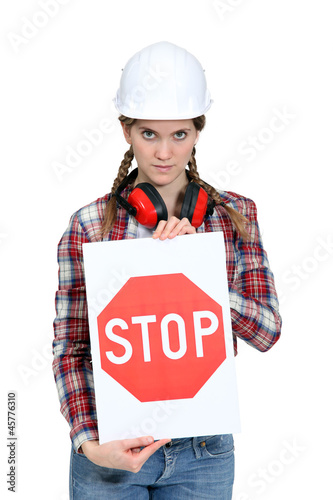 Photo: Construction worker holding a stop sign Construction worker holding a stop sign