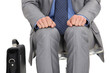 businessman waiting at station with briefcase by his side