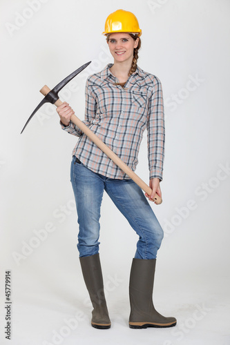 Photo: Woman posing with pick-ax Woman posing with pick-ax