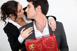 Couple with Christmas present about to kiss