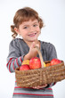 Young girl with a basket of apples
