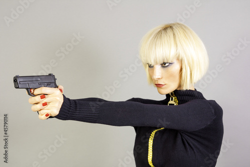 Photo: Blond sexy girl with gun Blond sexy girl with gun
