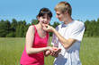 Husband feeds wife berry from hand