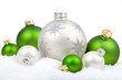 Christmas ornaments with snow - white and green , on a white 