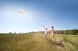 Husband, wife launch kite in field