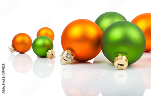 Illustration: Multi-colored Christmas ornaments - orange and green, on a whit Multi-colored Christmas ornaments - orange and green, on a whit