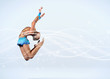 Young woman in gymnast suit posing