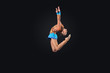 Young woman in gymnast suit posing