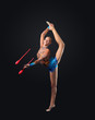 Young woman in gymnast suit posing