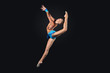 Young woman in gymnast suit posing