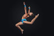 Young woman in gymnast suit posing