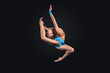 Young woman in gymnast suit posing