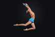Young woman in gymnast suit posing