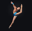 Young woman in gymnast suit posing