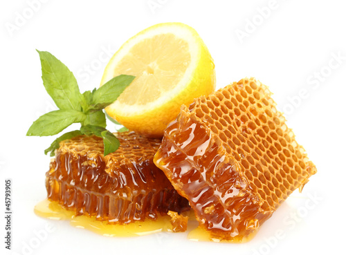 Photo: sweet honeycombs with lemon and mint, isolated on white sweet honeycombs with lemon and mint, isolated on white