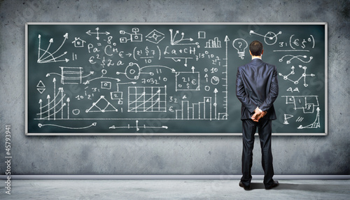 Photo: Business person against the blackboard Business person against the blackboard