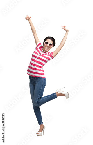 Photo: Happy dancing teenager with arms up, isolated Happy dancing teenager with arms up, isolated