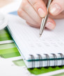 Close up of hand writing in the writing pad