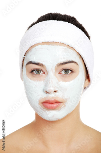 Photo: Beautiful woman with clay face mask Beautiful woman with clay face mask