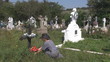 Beautiful woman bringing flower in cemetery