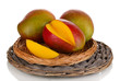 Ripe appetizing mango on wicker cradle isolated on white