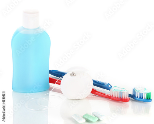 Photo: Toothbrush, chewing gum and dental floss isolated on white Toothbrush, chewing gum and dental floss isolated on white