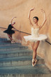 Young beautiful ballerinas dancing on the stairs. 