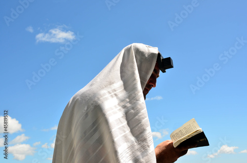 Photo: Jewish man pray to God under the open blue sky Jewish man pray to God under the open blue sky