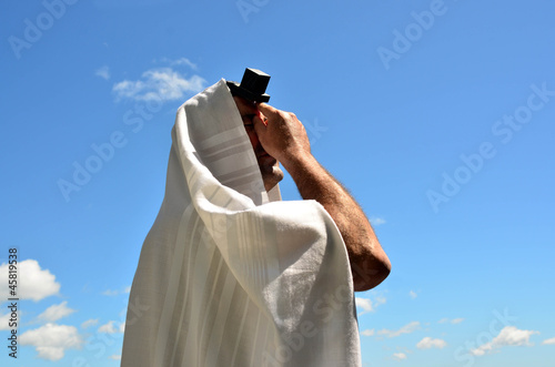 Photo: Jewish man pray to God under the open blue sky Jewish man pray to God under the open blue sky