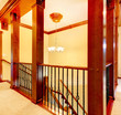 Luxury staircase with wood columns and metal railings.