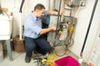 Plumber repairs furnace