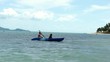 Mother and son kayaking at tropical sea