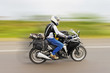 Motor biker rushing home from tour