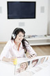 Young woman listening to music & chatting with friends