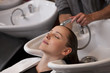 A woman having her hair washed in a hairdressers, close up