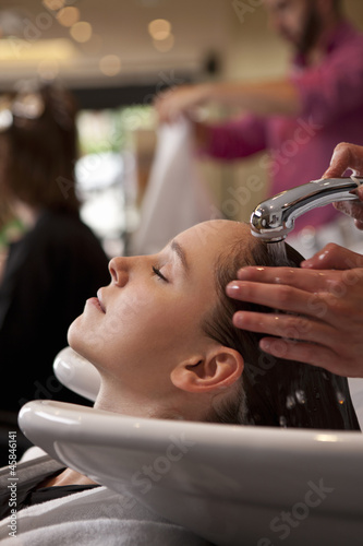Photo: A female client having her hair washed in a hairdressing salon A female client having her hair washed in a hairdressing salon