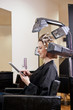 A woman using digital tablet whilst having her hair coloured