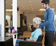Photo: A senior woman in hairdressing salon admiring her new hairstyle A senior woman in hairdressing salon admiring her new hairstyle