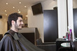 A male client looking in the mirror in a hairdressing salon